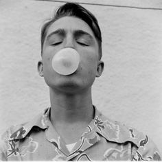 a man blowing a bubble with his nose