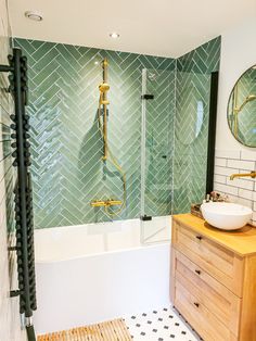 a bathroom with a sink, mirror and bathtub next to a stand up shower