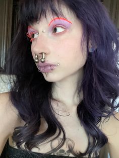 purple hair, dahlia bites, dahlia piercing, 2g septum, purple hair, unconventional makeup, orange makeup, purple makeup, orange and purple makeup, orange mascara, orange lashes, bridge piercing, forehead dermal, third eye piercing, snake bites, opal piercings Third Eye Dermal, Forehead Dermal Piercing, 2g Septum, Dalia Piercing, Dahlia Bites Piercing, Forehead Dermal, Orange And Purple Makeup, Orange Mascara, Orange Lashes