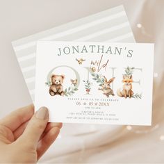 a person holding up a card with animals on it