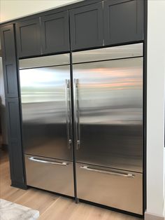 a stainless steel double door refrigerator in a kitchen