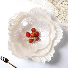 strawberries are placed in the center of a paper plate