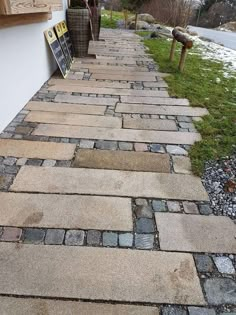 a brick walkway with two baskets on the side