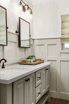 a large bathroom with two sinks and mirrors