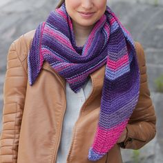 a woman wearing a purple and pink scarf