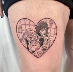 a woman with a heart shaped tattoo on her thigh