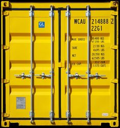 two yellow shipping containers sitting side by side with numbers on the sides and letters on the front