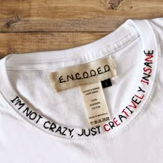 "White tee shirt with hand-embroidered funny phrase \"I'm not crazy, just creatively insane\".  MATERIAL 100% cotton. SIZES You can finde size guide on the photo area. Please check the size before the buying. GARMENT CARE Delicate machine wash at 30 degrees. DELIVERY ESTIMATES Next 1-2 working days dispatch. SPAIN customers - estimated delivery 3-5 working days. EUROPEAN customers - estimated delivery 5-10 working days. INTERNATIONAL customers - Estimated delivery 14-21 working days. Choose your mood!" Unisex Christmas Gifts, White Tee Shirt, White Short Sleeve Shirt, Slogan Shirts, Slogan Tshirt, White Tee Shirts, Funny Slogans, Painted Denim, Im Crazy