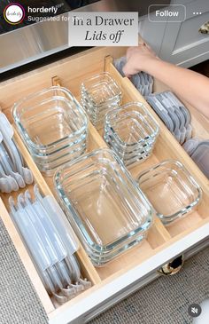 an open drawer filled with dishes and utensils