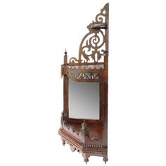 an old wooden mirror hanging on the wall