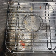 a metal grate filled with lots of rocks and gravel on top of a table