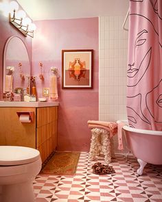 a bathroom with pink walls and checkered flooring