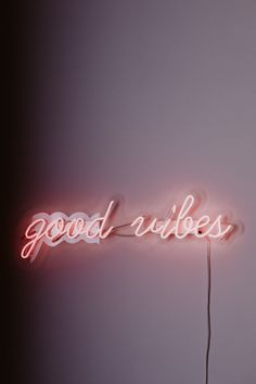 a neon sign that says good vibes on it