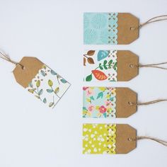 four tags with flowers and leaves on them