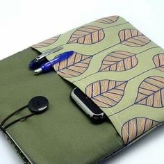 an ipad case with a cell phone and pen in it