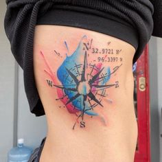 a woman with a compass tattoo on her stomach