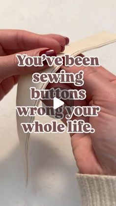 two hands are holding a piece of paper with the words, you've been sewing buttons wrong your whole life