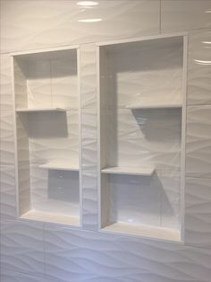 a white wall with some shelves in it