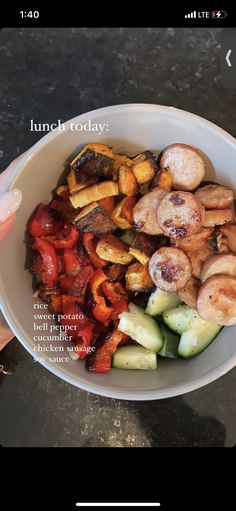 a person holding a white bowl filled with different types of food on top of a table