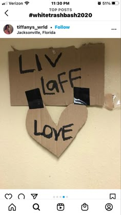 two cardboard hearts with the words live life love written on them, attached to a wall