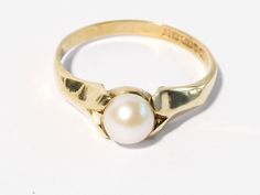 Here is a vintage 9ct gold real Pearl solitaire ring. The Pearl is a lovely creamy white colour and sits between petal shaped shoulders. This is not a faux pretend Pearl it is a real pearl and probably cultured. It is hallmarked to the inner shank for Birmingham England 9ct gold 375 1965 and the makers mark is C.P.S. It is a UK size q. 1/2 and a US size 8. 1/2. The Pearl measures approx 5.75mm in diameter. The height of the whole mount from the finger to the top of the Pearl measures 6mm. It wei Birmingham England, Real Pearls, Lovely Ring, Pearl Wedding, White Colour, The Pearl, Gold Pearl