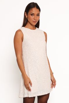 DETAILS   Transform your nights out with our stunning Sequin Mini Dress. This isn't just a dress; it's your ticket to turning heads, feeling fabulous, and making memories in style.    mini length  round neckline  sleeveless  open back with tie close feature  invisible side zip  shirred back panel   sequin design  lined   material - 100% polyester / lining - 95% polyester, 5% spandex    SIZING     studio model is 5' 8" and wears a Size XS    model stats: bust - 31", waist - 24", hips - 35" Satin Dresses Long, Satin Dresses Long Sleeve, Black Tie Wedding Guests, White Dress Shoes, Sequin Design, Resort Dresses, Crop Top Tees, Bridesmaid Outfit, Dresses By Length