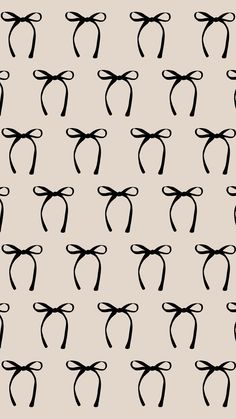 a pattern with black bows on a gray background