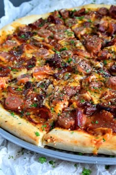 a pizza sitting on top of a pan covered in toppings