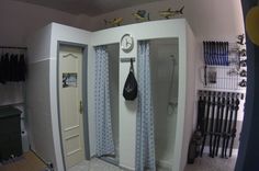 a bathroom with two shower stalls and a clock on the wall