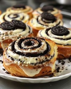 several pastries on a white plate with oreo cookies and cream frosting in the middle