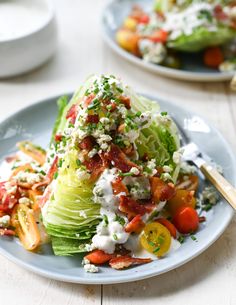 lettuce and tomato salad with dressing on two plates