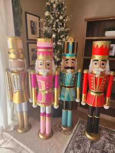 three nutcrackers are standing next to a christmas tree in a living room