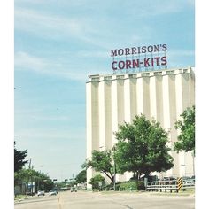 a large sign on the side of a building that says,'morrison's corn - kits '