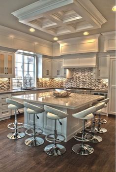 a large kitchen island with four stools in it