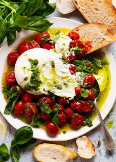 a white plate topped with bread and tomatoes