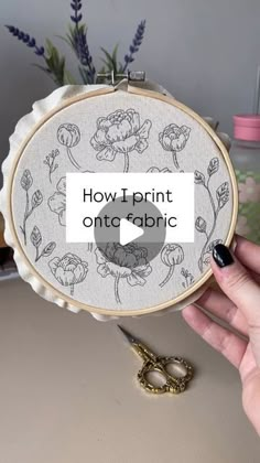 someone is holding up an embroidery project with the words how to print onto fabric