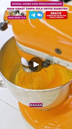 an orange blender is being used to make smoothies