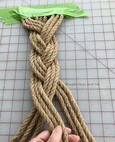 someone is making a piece of rope out of twine