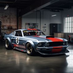 an old muscle car is parked in a garage with red and white stripes on it