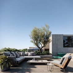 an outdoor living area with couches and tables