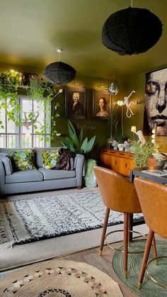 a living room filled with lots of furniture and pictures on the wall next to a table