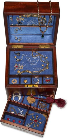 an open wooden box with jewelry in it