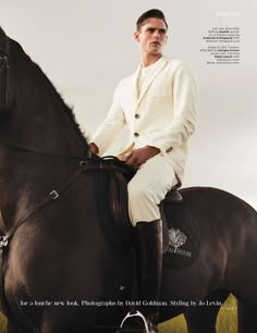 a man sitting on top of a brown horse wearing a white suit and riding boots