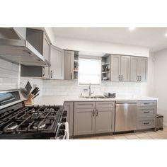 a kitchen with stainless steel appliances and cabinets