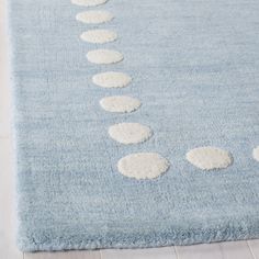 a blue rug with white circles on it