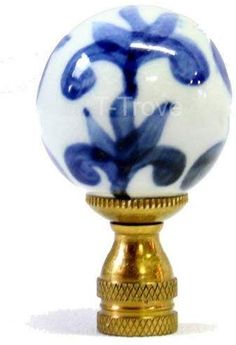 a blue and white glass ball on a gold stand