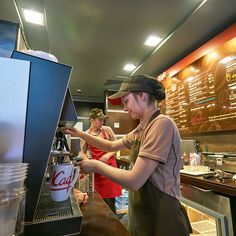 a woman is working behind the counter at a restaurant