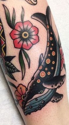 a close up of a person's leg with tattoos on it and an animal