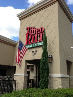 the front of a restaurant with an american flag on it