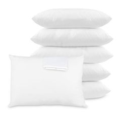 white pillows stacked on top of each other with a note pinned to the pillow cover